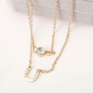 Gold horseshoe necklace with "good-luck" word